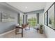 Bright office with a wooden desk, comfortable seating, and a sliding door to the outdoor space at 109 Ailey Brook Way # 100, Wake Forest, NC 27587