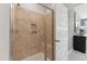 Walk-in shower features neutral tile, glass door, and built-in shelving at 109 Ailey Brook Way # 100, Wake Forest, NC 27587