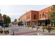 Charming town center featuring brick buildings, storefronts, and outdoor seating areas, with a water tower in the distance at 109 Ailey Brook Way # 100, Wake Forest, NC 27587