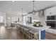 Open kitchen boasts white cabinets, stainless steel appliances, and a blue island at 111 Ailey Brook Way # 200, Wake Forest, NC 27587