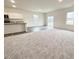 Open concept kitchen and living area with vinyl plank and carpeted floor at 115 N North Keatts Winner Ct, Clayton, NC 27520