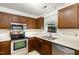 Galley kitchen with stainless steel appliances and wood cabinets at 117 London Plain Ct, Cary, NC 27513