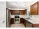 Galley kitchen with stainless steel appliances and wood cabinets at 117 London Plain Ct, Cary, NC 27513