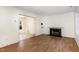 Bright living room features hardwood floors and a fireplace at 117 London Plain Ct, Cary, NC 27513