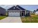 Charming single-Gathering home with stone accents, a two-car garage, and a well-maintained front lawn at 121 Northwood Dr, Fuquay Varina, NC 27526