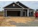 New construction home featuring a stone facade, attached garage, and contemporary design at 121 Northwood Dr, Fuquay Varina, NC 27526