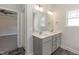 Bathroom vanity with dual sinks, large mirror, and modern lighting at 128 High Hampton Way, Fuquay Varina, NC 27526