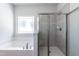 Bathroom features a glass door shower and separate soaking tub at 128 High Hampton Way, Fuquay Varina, NC 27526