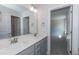Well-lit bathroom showcasing a double vanity with white countertops and a mirrored wall at 128 High Hampton Way, Fuquay Varina, NC 27526