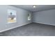 Spacious bedroom with two windows and grey carpet at 128 High Hampton Way, Fuquay Varina, NC 27526