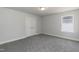 The bedroom has gray carpet, and a double door closet and is illuminated by natural light through a window at 128 High Hampton Way, Fuquay Varina, NC 27526