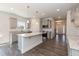 Modern kitchen with a large island, gray cabinets, granite countertops, and stainless steel appliances at 128 High Hampton Way, Fuquay Varina, NC 27526