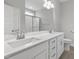 Double vanity bathroom with white cabinets, quartz countertops, and a large mirror at 129 Colby Farm Dr, Kenly, NC 27542