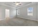 Main bedroom with ceiling fan, walk-in closet, and carpet flooring at 129 Colby Farm Dr, Kenly, NC 27542