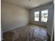 Spacious carpeted bedroom with two windows offers ample natural light and a bright, airy feel at 141 Trescott St, Smithfield, NC 27577