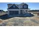 Two-story house with blue and gray siding, attached garage, and unfinished landscaping at 141 Trescott St, Smithfield, NC 27577