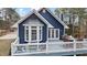 Charming blue home featuring a large deck, bay window, and outdoor seating area at 146 Buoy Dr, Henderson, NC 27537