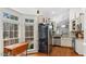 Kitchen with stainless steel refrigerator, granite counters, and mosaic backsplash, plus breakfast nook with large bay window at 146 Buoy Dr, Henderson, NC 27537