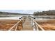 Long wooden dock extending into a lake with multiple boat slips at 146 Buoy Dr, Henderson, NC 27537