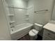Bright bathroom featuring a tub with shower and white vanity with sleek fixtures at 15 Long Needle Ct # 38, Youngsville, NC 27596