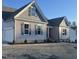 Two-story home with gray siding, attached garage, and landscaped yard at 15 Long Needle Ct # 38, Youngsville, NC 27596