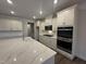 Bright kitchen features quartz countertops, stainless appliances, and ample cabinet space at 15 Long Needle Ct # 38, Youngsville, NC 27596