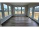 Sunroom with hardwood floors, large windows, and access to the outdoor deck at 15 Long Needle Ct # 38, Youngsville, NC 27596