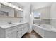 Bright bathroom featuring double sink vanity, soaking tub, and lots of natural light at 1696 James Winston Rd, Oxford, NC 27565
