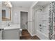 Bathroom featuring white sink vanity, shower and storage at 1696 James Winston Rd, Oxford, NC 27565