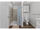 Bathroom featuring tiled walk-in shower, linen closet and modern toilet at 1696 James Winston Rd, Oxford, NC 27565