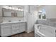 Bright bathroom featuring double sink vanity, soaking tub, and lots of natural light at 1696 James Winston Rd, Oxford, NC 27565