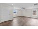 Bedroom with door, two windows and wood floors at 1696 James Winston Rd, Oxford, NC 27565