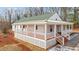 Charming home featuring a spacious porch, white siding, and a green roof at 1696 James Winston Rd, Oxford, NC 27565