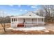 Charming white farmhouse with a wraparound porch at 1696 James Winston Rd, Oxford, NC 27565