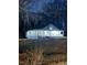 Well-lit home at dusk featuring a covered porch at 1696 James Winston Rd, Oxford, NC 27565