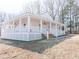 Beautiful white house with a wraparound porch, offering ample space for outdoor living at 1696 James Winston Rd, Oxford, NC 27565