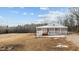 Stunning white house with a large porch, perfect for enjoying the serene surroundings at 1696 James Winston Rd, Oxford, NC 27565