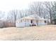 Charming white home with a spacious porch, perfect for enjoying the outdoors at 1696 James Winston Rd, Oxford, NC 27565