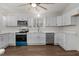 Bright kitchen features white cabinets, stainless steel appliances and wood floors at 1696 James Winston Rd, Oxford, NC 27565