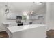 Modern kitchen featuring white cabinetry, stainless steel appliances, and a center island at 1696 James Winston Rd, Oxford, NC 27565