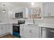 Modern kitchen with white cabinets and quartz countertops at 1696 James Winston Road Rd, Oxford, NC 27565