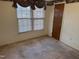 Bedroom with carpet, window, and door to hallway at 201 Providence Rd, Oxford, NC 27565