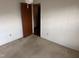 Bedroom with carpet, door, and wall-mounted light at 201 Providence Rd, Oxford, NC 27565