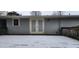 Wooden deck with double doors leading inside, snow-covered at 201 Providence Rd, Oxford, NC 27565