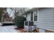 Home's back with gray siding, AC unit, deck, and snowy yard at 201 Providence Rd, Oxford, NC 27565