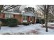 Brick ranch home with red shutters and gray accents, snow covered yard at 201 Providence Rd, Oxford, NC 27565