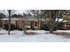Brick ranch home with red shutters, covered porch, and snow-covered yard at 201 Providence Rd, Oxford, NC 27565