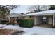 Brick ranch home with gray siding, covered porch, and snow-covered yard at 201 Providence Rd, Oxford, NC 27565