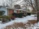Brick ranch home with gray siding and landscaping, snow-covered yard at 201 Providence Rd, Oxford, NC 27565
