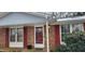 Brick ranch house with red shutters, front door, and porch at 201 Providence Rd, Oxford, NC 27565